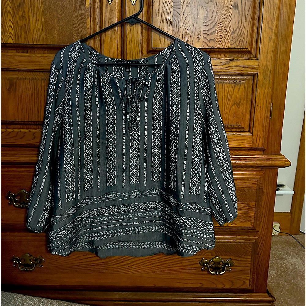 Grey blouse with white designs down it. True to size.